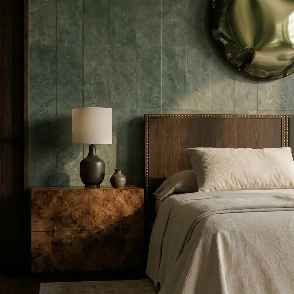 Detail of burl wood nightstand and walnut headboard against green panelled wallpaper