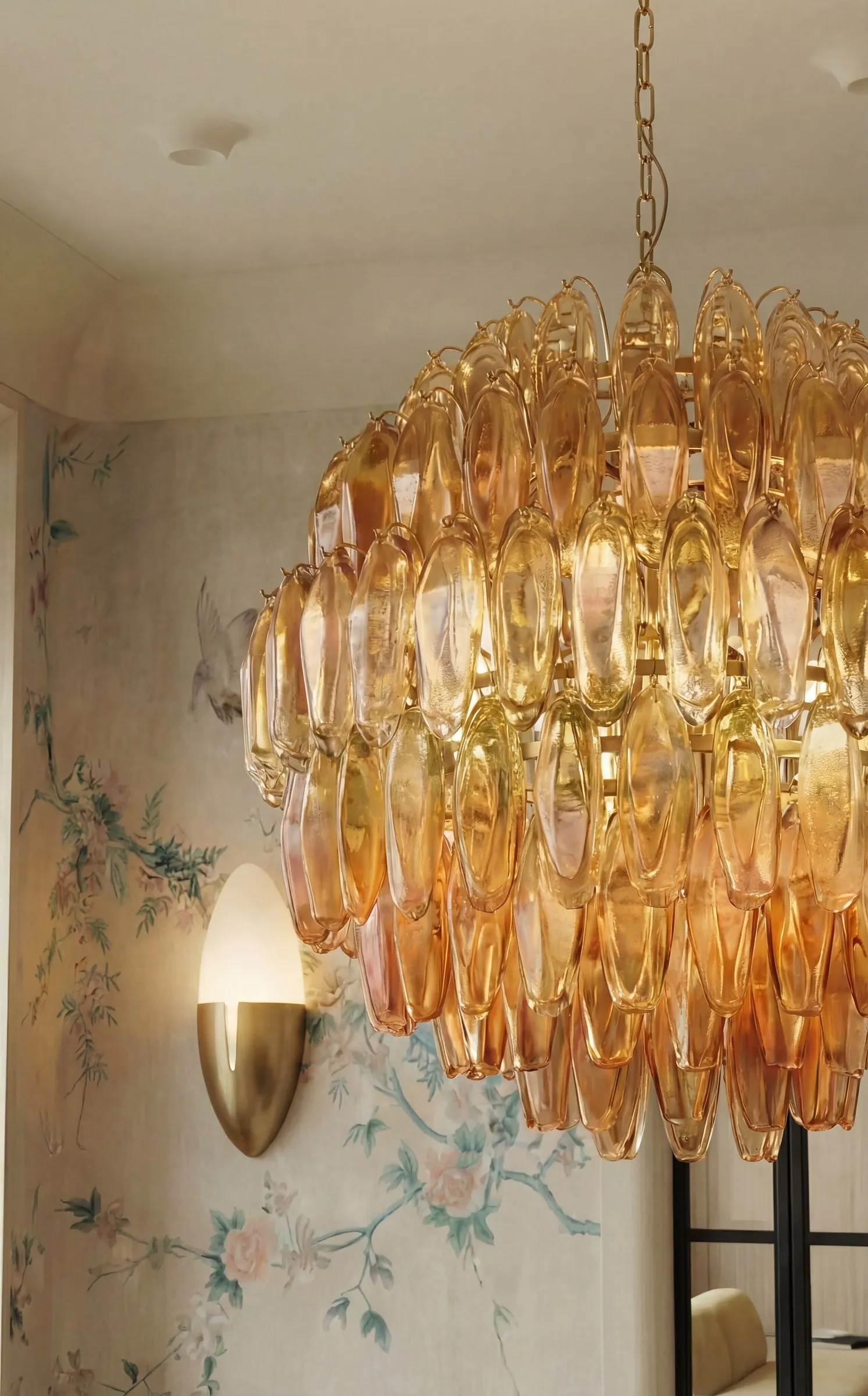 Amber crystal chandelier against chinoiserie wallpaper