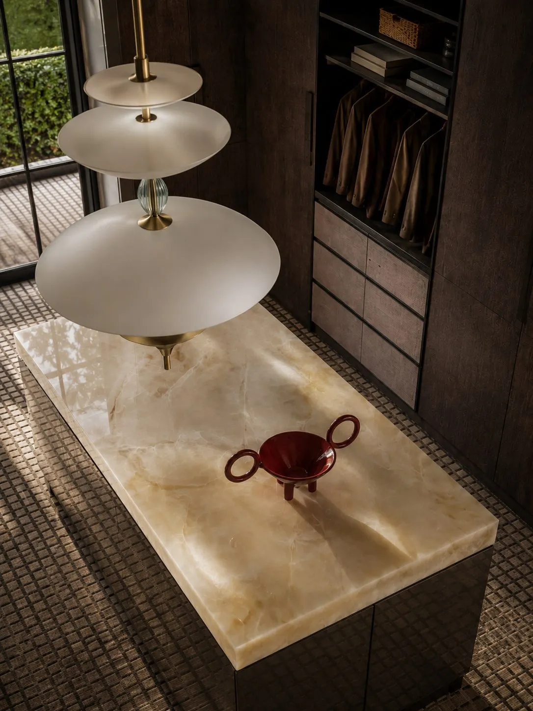 Detail of the onyx-topped dressing island under layered pendant lights