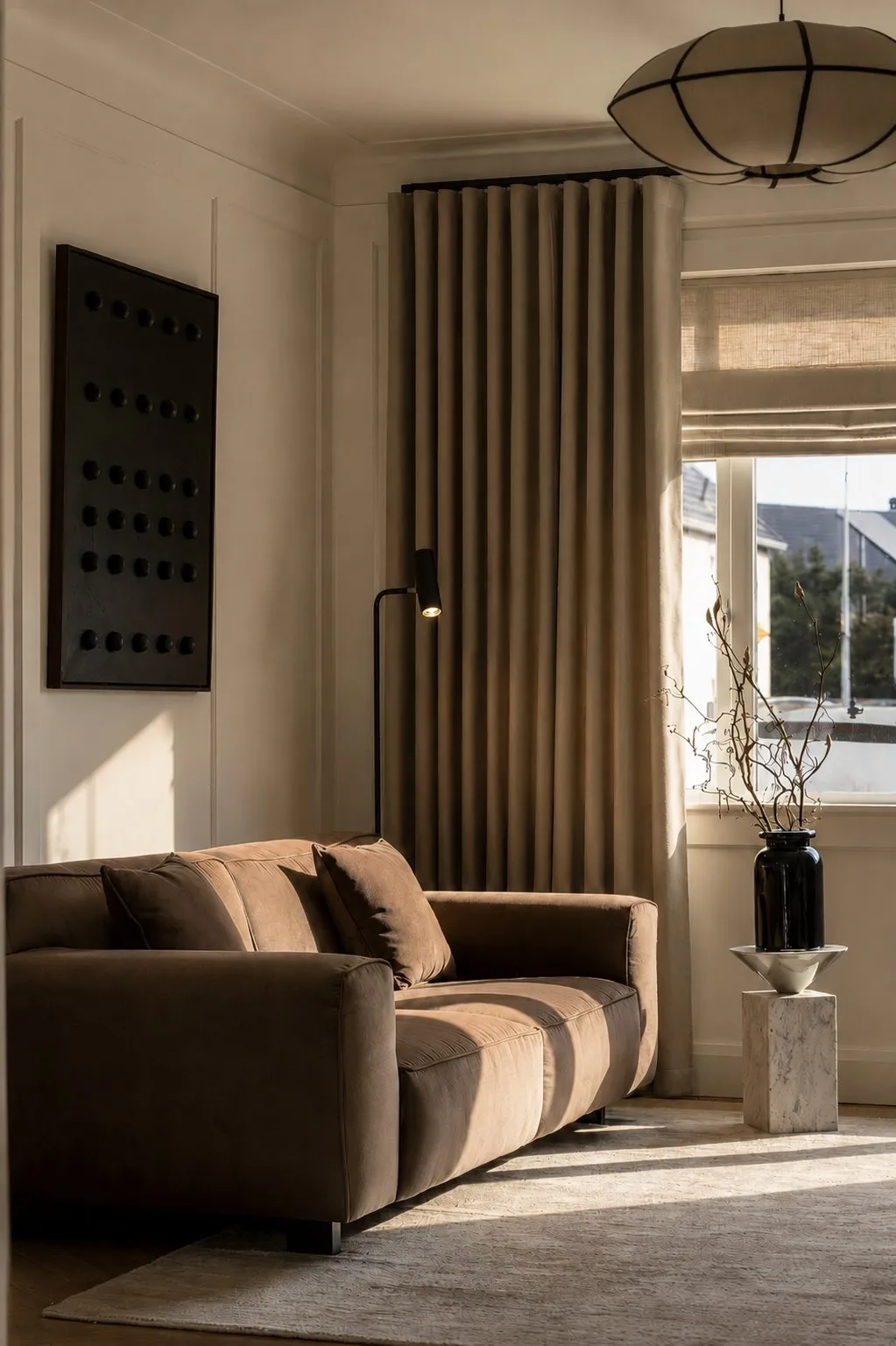 Velvet sofa and floor lamp in the family living room with soft natural light
